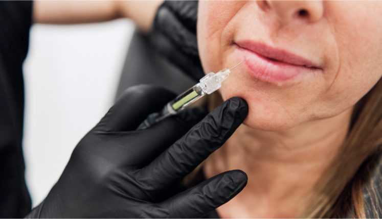 a young woman injecting botox