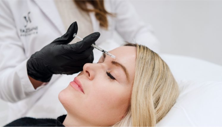 a professional injecting Botox into a patient's face